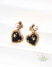 Close-up of Black Agate Heart Earrings showcasing smooth polished agate and 18K gold settings.