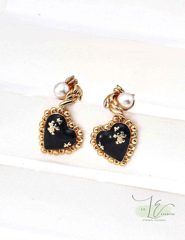 Close-up of Black Agate Heart Earrings showcasing smooth polished agate and 18K gold settings.