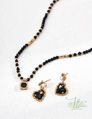 Model wearing Black Agate Heart Earrings, highlighting the secure French wire backs".