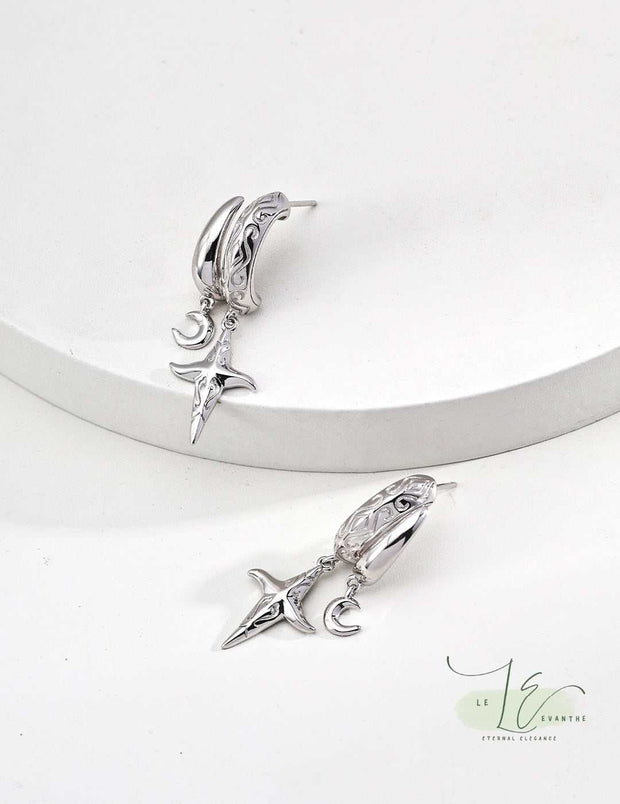 Close-up of Moon Star Hoop Earrings showcasing the intricate moon and star charms, handcrafted in hypoallergenic sterling silver with 18K gold plating for lasting shine.