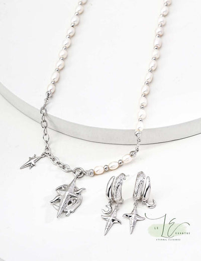 Model wearing the Moon Star Necklace at collarbone length, demonstrating its versatile 18" chain. The celestial motif and pearl add subtle sophistication to any outfit.
