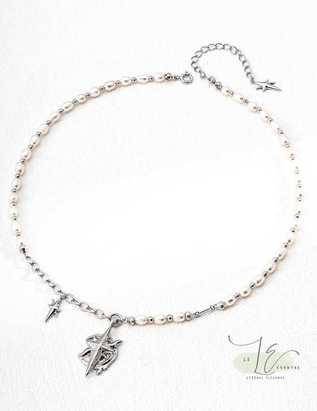 Close-up of the Moon Star Necklace’s pendant, showcasing the intricate moon and star design with a lustrous pearl accent. Crafted in hypoallergenic sterling silver and 18K gold plating.