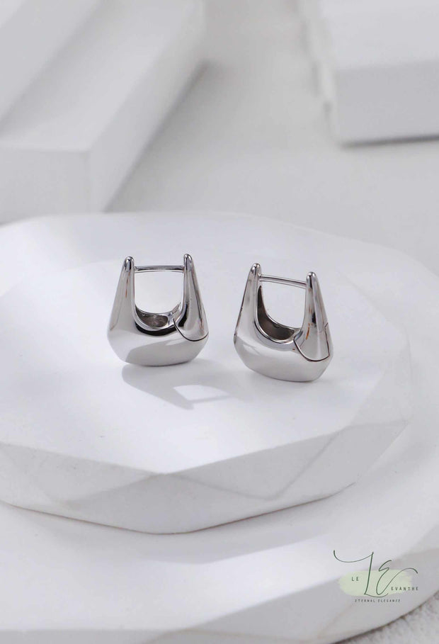 Side view of Geometric Hoop Earrings highlighting the dimensional handbag structure. The open-back design keeps them lightweight while making a bold statement.