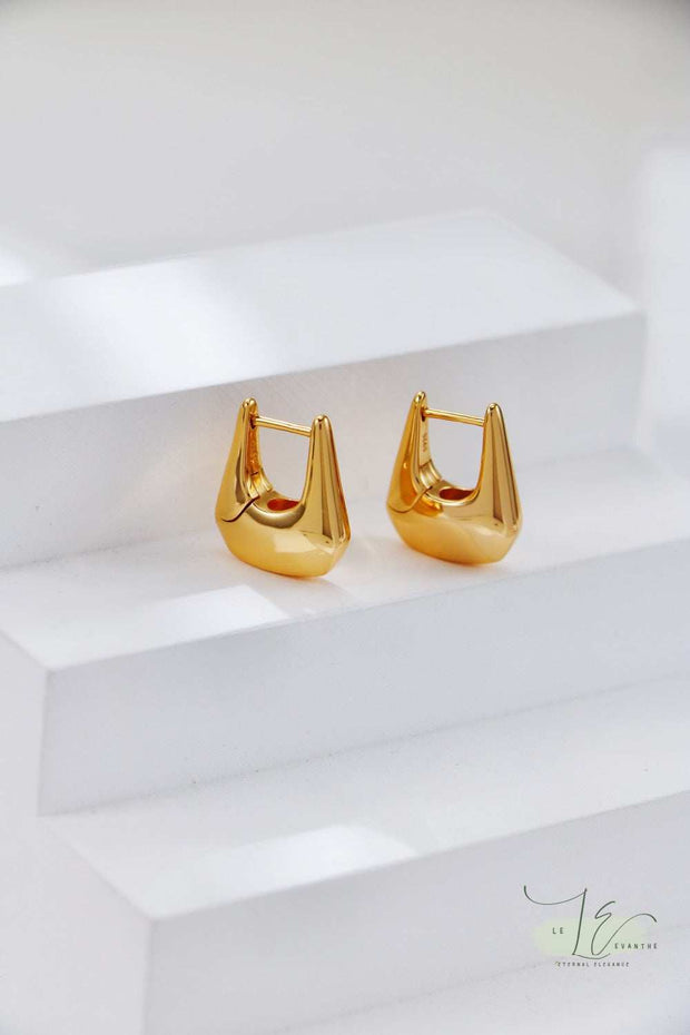 Macro shot of Geometric Hoop Earrings' textured gold plating, emphasizing the contrast with the polished silver framework for a high-end look.