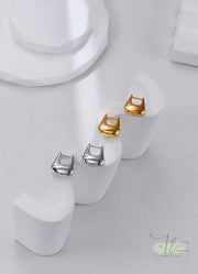 How-to video still: Adjusting Geometric Hoop Earrings' secure latch back. The ergonomic closure prevents snagging while keeping the architectural shape intact.