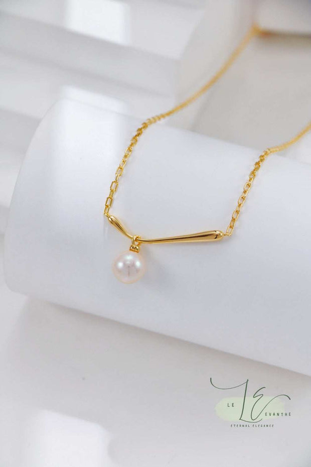 Model wearing the Minimalist Pearl Pendant Necklace at 16" length, demonstrating its perfect collarbone fit. The adjustable chain allows customization for layering with other necklaces.