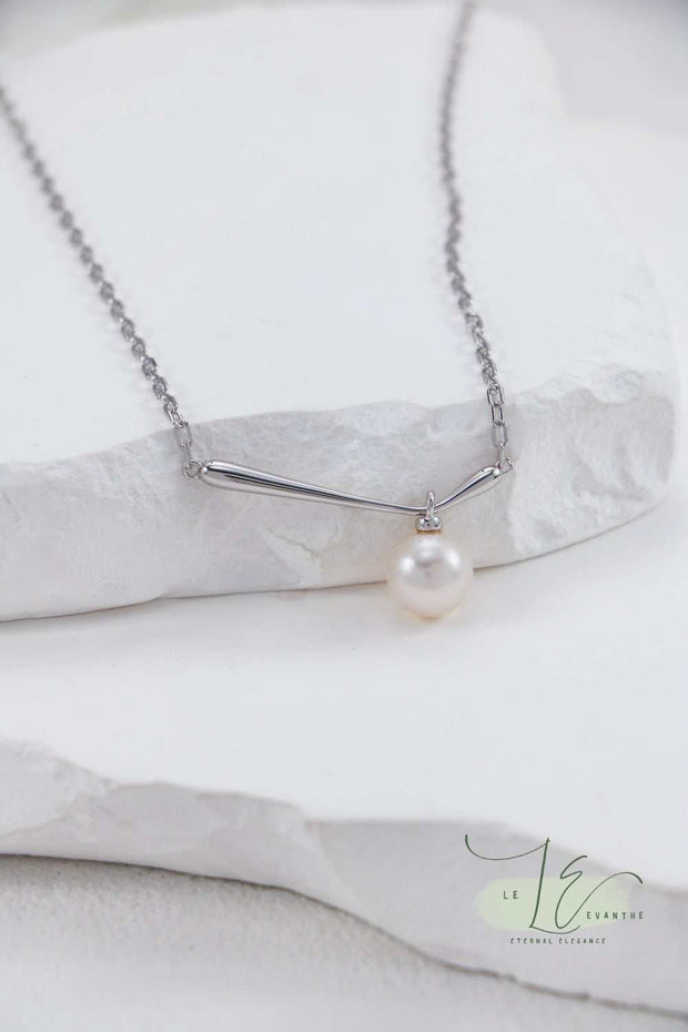 Close-up of the Minimalist Pearl Pendant Necklace’s pearl, showcasing its flawless symmetry and lustrous surface. The 18K Gold bail adds a subtle touch of luxury to the sterling silver chain.
